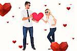 Cool young couple holding red heart against hearts