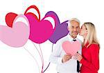Handsome man holding paper heart getting a kiss from wife against valentines love hearts