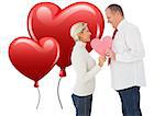 Older affectionate couple holding pink heart shape against heart balloons