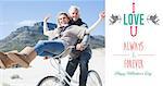 Carefree couple going on a bike ride on the beach  against i love you message