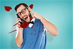 Geeky hipster talking on a retro cellphone against blue vignette background