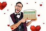 Geeky hipster holding a retro radio against hearts