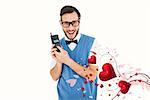 Geeky hipster holding a retro cellphone against valentines heart design