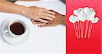 Couple having coffee together holding hands against hearts