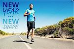 Athletic man jogging on open road holding bottle  against new year new shape