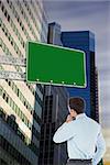 Thoughtful businessman with hand on chin against low angle view of skyscrapers