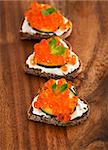 Heart shaped toasts appetizer with red caviar