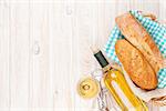 White wine and bread on white wooden table background with copy space