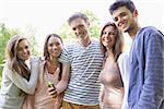 Happy students looking at smartphone outside on campus at the university