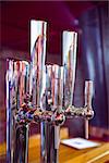 Shiny beer taps in a row in a bar