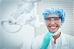 Portrait of female dentist wearing surgical cap and safety glasses