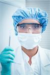 Portrait of female dentist wearing surgical mask and safety glasses