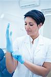 Female dentist wearing surgical glove