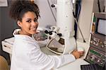 Biochemistry student using large microscope at the university