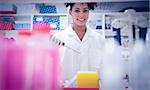 Pretty science student using pipette at the university