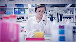 Pretty science student using pipette at the university