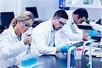 Science students working with chemicals in lab at the university