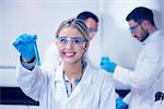 Science student holding up test tube at the university