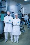 Food technicians smiling at camera in a food processing plant