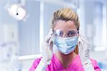Dentist in surgical mask and protective glasses at the dental clinic