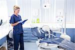 Dentist working on tablet pc at the dental clinic