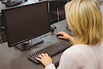 Mature student looking at computer screen in the office