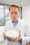 Pharmacist showing bowl of pills at the hospital pharmacy