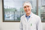 Happy pharmacist in a hairnet at the hospital pharmacy