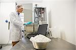 Pharmacist using heavy machinery to make medicine at the laboratory