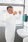 Pharmacist washing his hands at sink at the laboratory