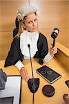 Stern judge banging her hammer in the court room