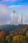 Mist from Horseshoe Falls swirling in front of Skylon Tower at dawn, Niagara Falls, Niagara, Ontario, Canada, North America