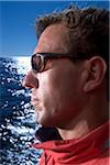 Close-up portrait of man wearing sunglasses while sailing along the coast of Maine, USA.
