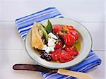 Fresh Salad with Heirloom Tomatoes, Kalamata Olives, Baguette, Basil and Cheese on White Table, Outdoors, Canada