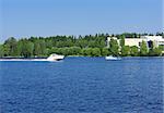 Boat sailing in the lake with city view on background