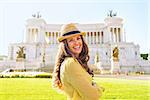 Portrait of smiling young woman on piazza venezia in rome, italy