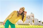 Portrait of happy young woman on piazza venezia in rome, italy