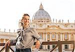 Portrait of happy young woman in front of basilica di san pietro in vatican city state