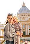 Portrait of happy mother and baby girl on piazza san pietro in vatican city state