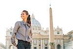 Happy young woman sightseeing on piazza san pietro in vatican city state