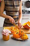 Closeup on young housewife cutting pumpkin for pickling