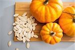 Closeup on small pumpkins and seeds on table