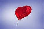 Red heart balloon against purple vignette