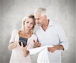 Anxious couple working out their bills against weathered surface