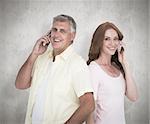 Casual couple on their phones against white background