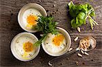 Poached eggs in metal dishes