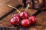 Freshly washed cherries on a wooden crate