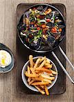 Mussels in a vegetable and herb broth served with fries and aioli