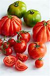 Various types of tomatoes with drops of water