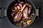 Leg of lamb in red wine with onions, carrots and rosemary